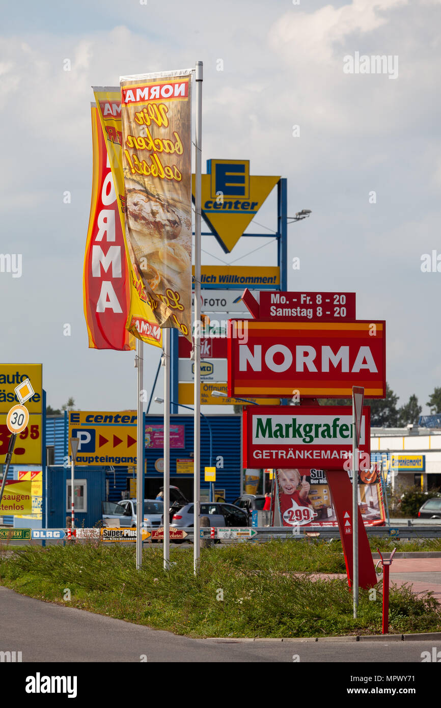 BAMBERG / GERMANY - SEPTEMBER 11th, 2010: Signs and flags of several German supermarkets at a suburban shopping mall Stock Photo