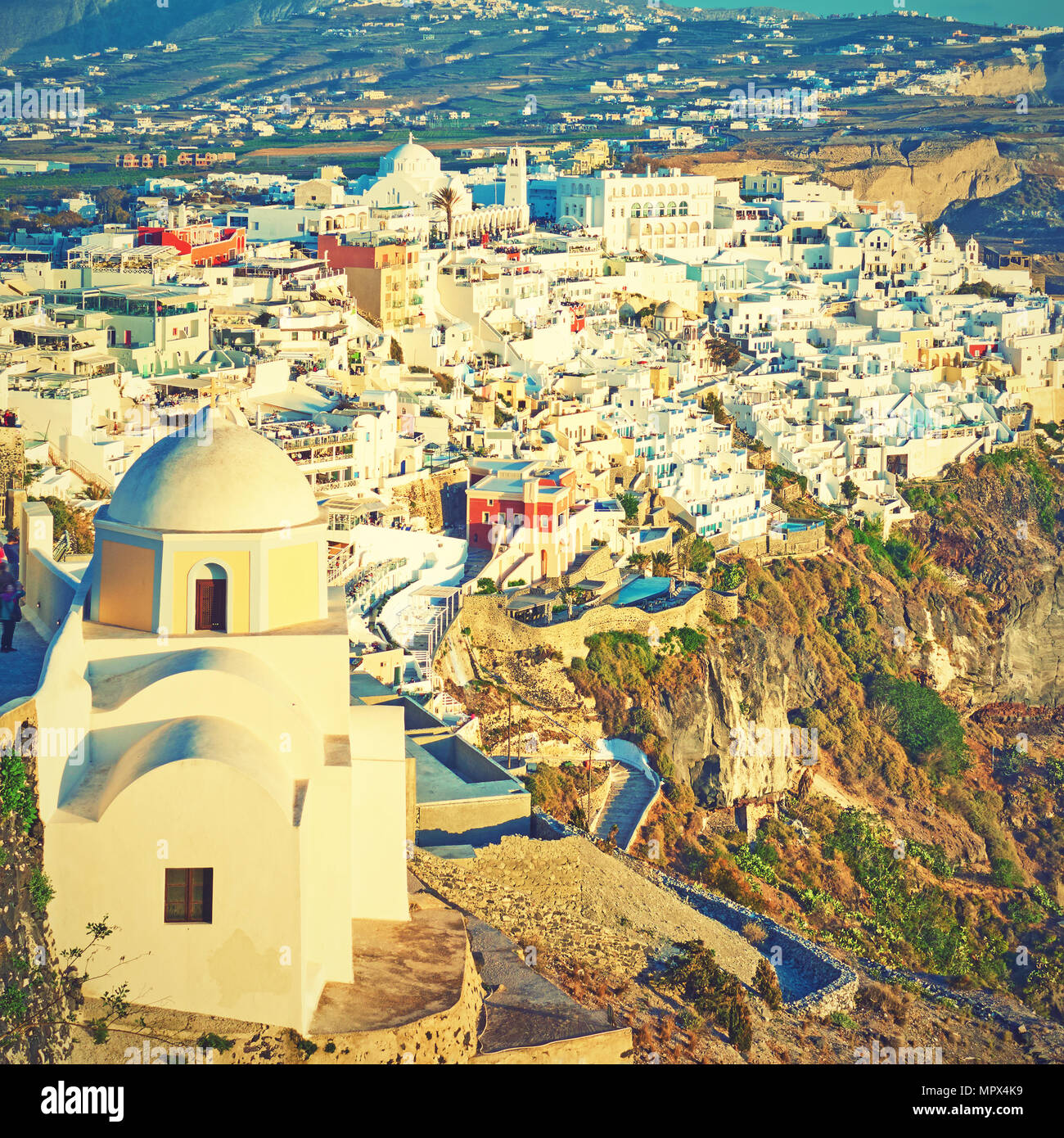 Thira town on an edge of rock, Greece.  Vintage style toned Stock Photo