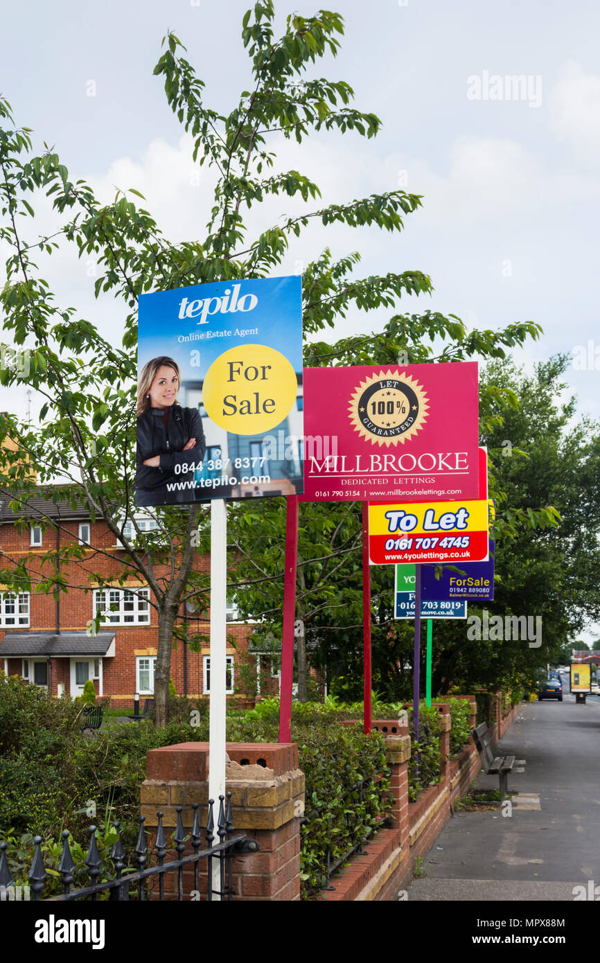 Property for sale and to let signs from a variety of estate agents outside a block of modern apartments, Hatherton Court, Worsely Road North, Walkden, Stock Photo