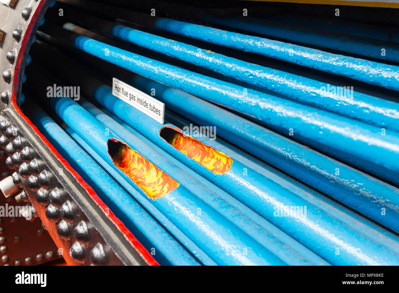 Steam engine boiler tubes displayed in a museum exhibit as a cutaway view. Stock Photo