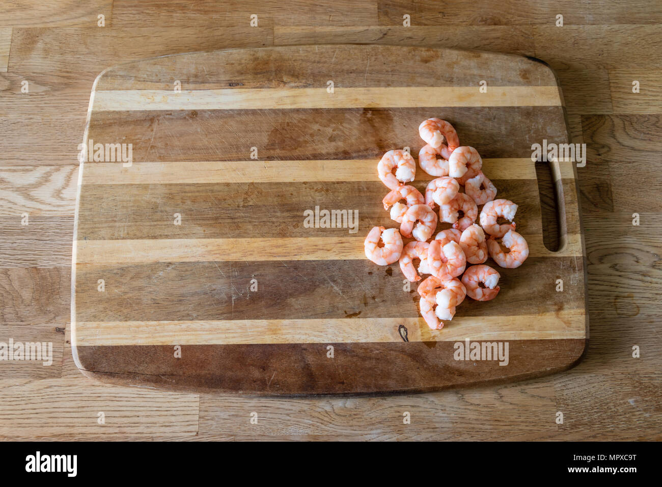 Raw prawns on a chopping board Stock Photo