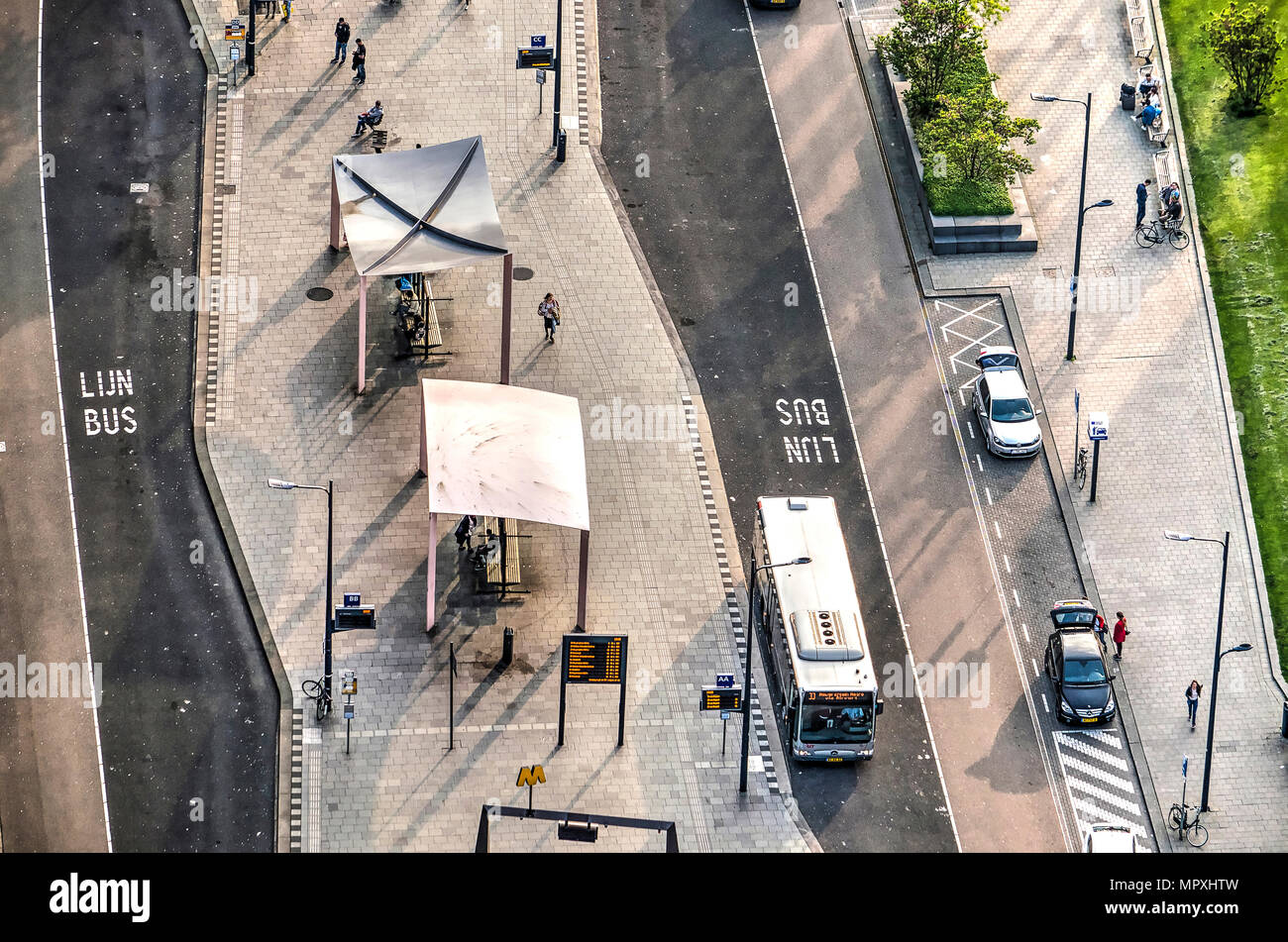 Rotterdam, The Netherlands, May 11, 2018: Close-up of the central busstation seen from above, with a city bus, shelters and a kiss and ride zone Stock Photo