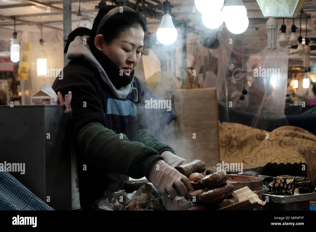 Stallholder Selling Traditional Korean Food In Gwangjang Market In The City Of Seoul Capital Of The Republic Of Korea Commonly Known As South Korea Stallholder Selling Traditional Korean Food In Gwangjang Market In The City Of Seoul Capital Of The Republic Of Korea Commonly Known As South Korea