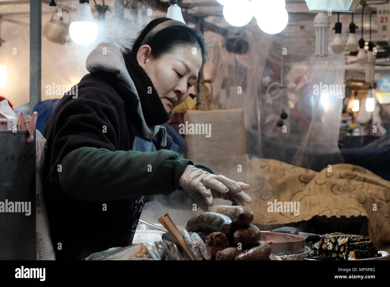 Stallholder Selling Traditional Korean Food In Gwangjang Market In The City Of Seoul Capital Of The Republic Of Korea Commonly Known As South Korea Stallholder Selling Traditional Korean Food In Gwangjang Market In The City Of Seoul Capital Of The Republic Of Korea Commonly Known As South Korea