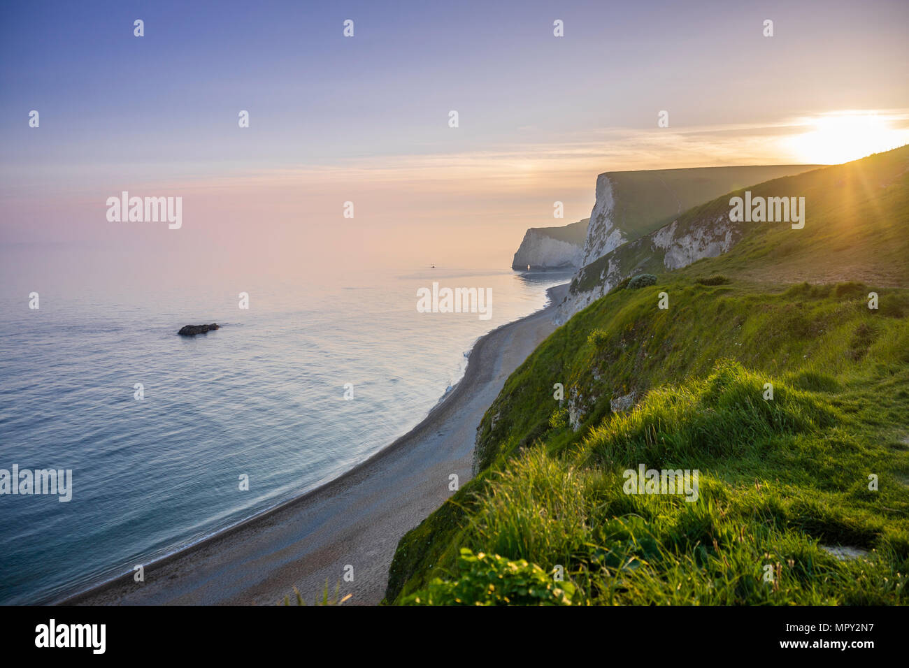 Blue hour ssunset over the Jurassic Coast with view to the white cliffs of Bats Head, UNESCO Natural World Heritage Site, Dorset, England, UK Stock Photo