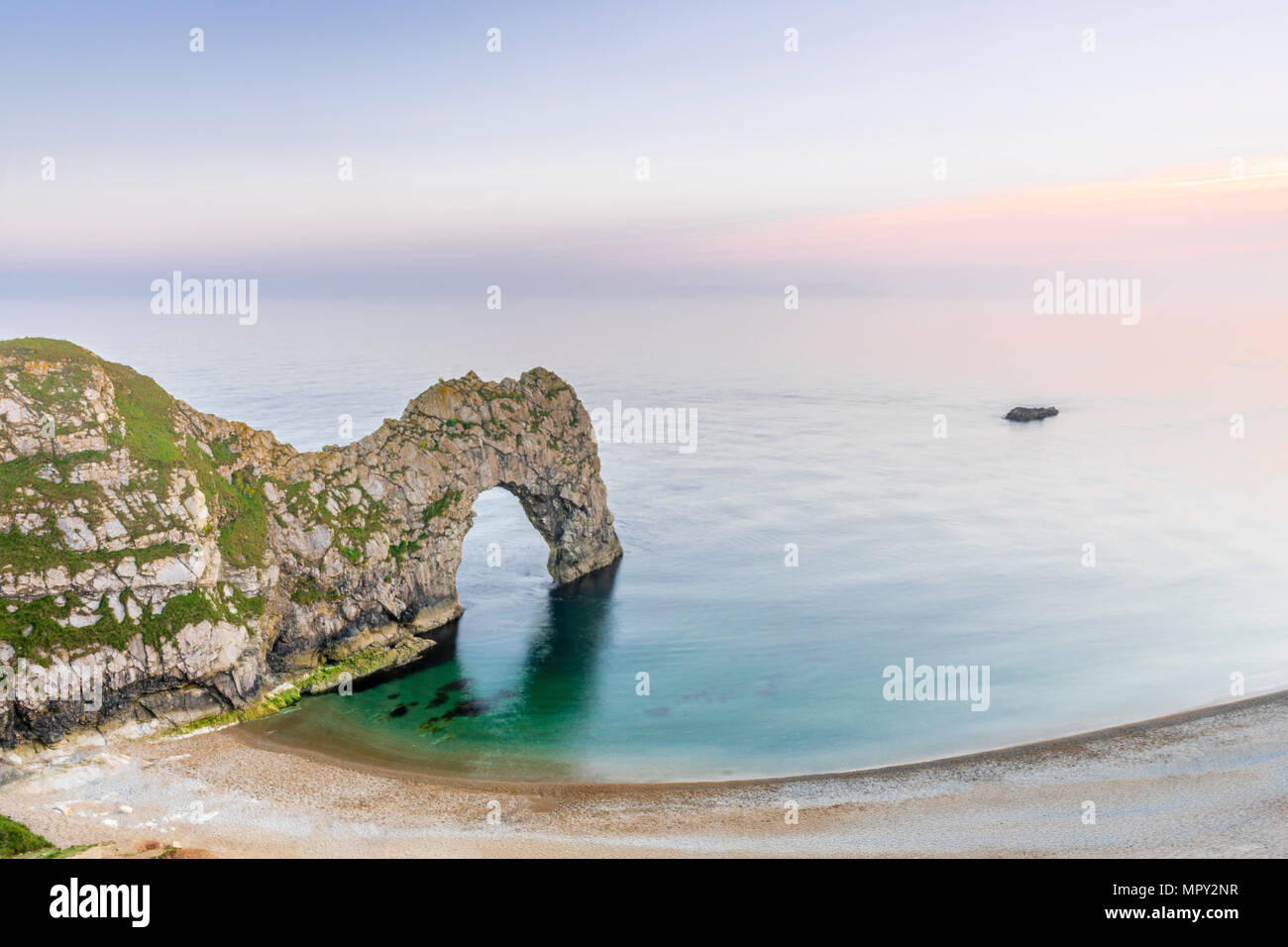 The famous arch rock formation at Durdle Door along the Jurassic Coast basked in sunset light, UNESCO Natural World Heritage Site, Dorset, England, UK Stock Photo