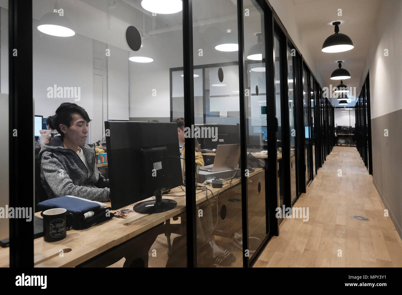 Young Koreans using computers as they work at WeWork Coworking and Office  Space located in Yeoksam Station in Seoul capital of South Korea. WeWork is  an American company which provides shared workspaces,