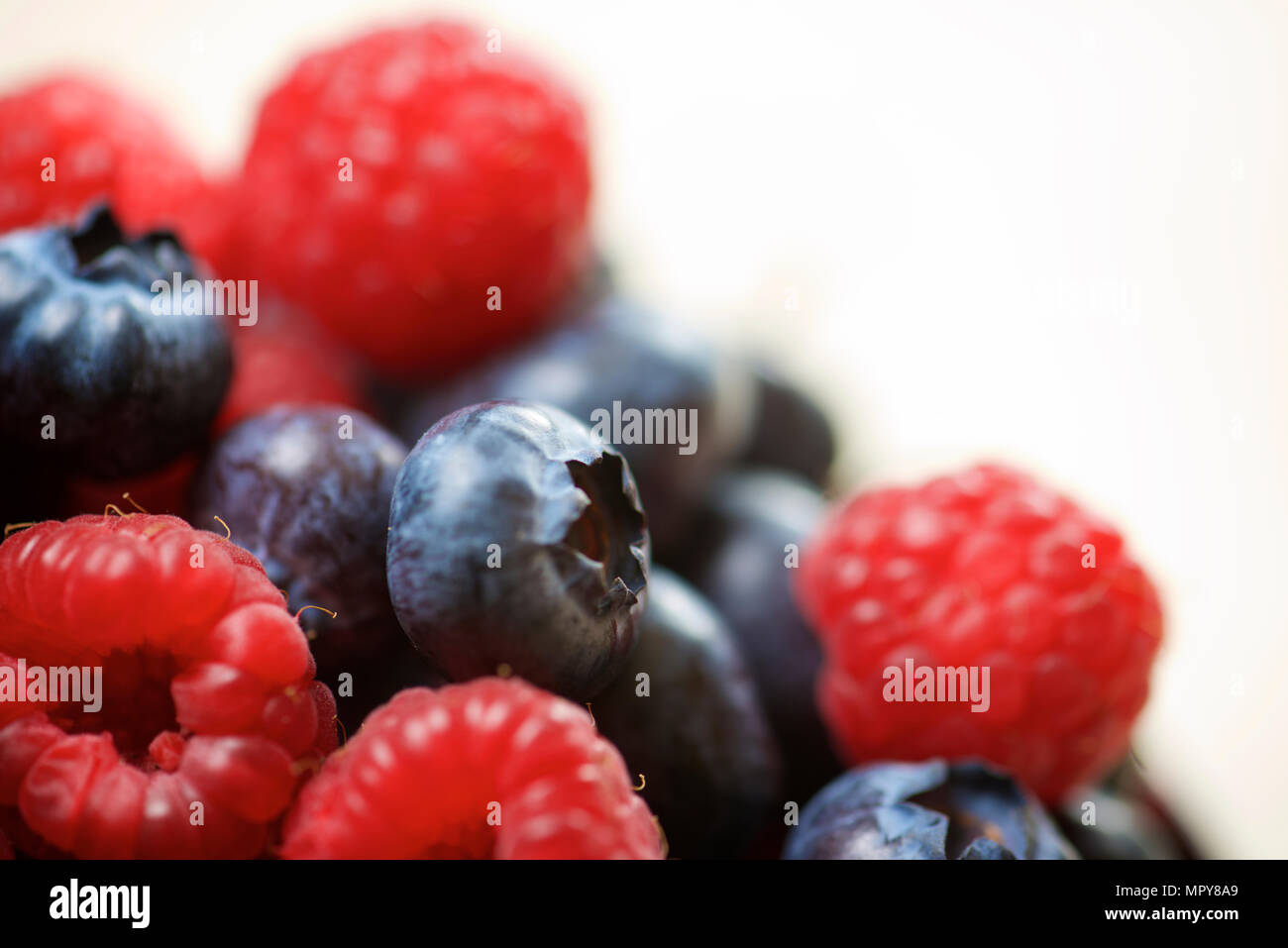 Close-up of berry fruits against white background Stock Photo - Alamy