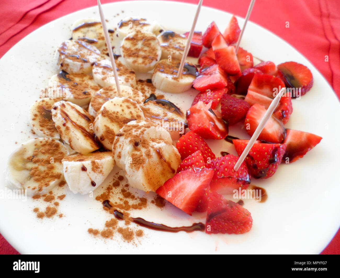 An after dinner dessert of Sliced Banana and Strawberry with a Demerara sugar and balsamic glaze, served in a Greek restaurant in Rhodes Old Town Stock Photo