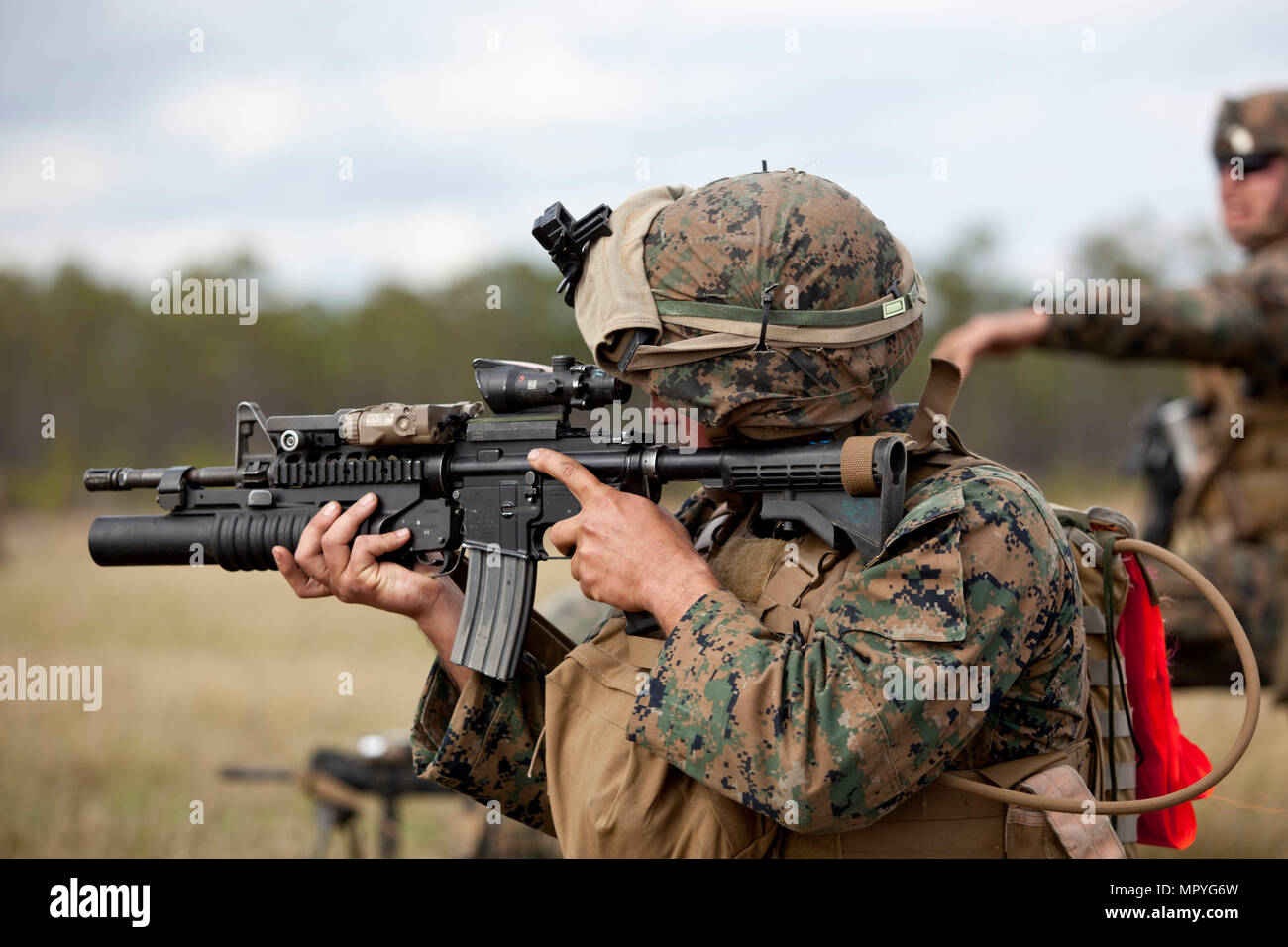 A U.S. Marine attached to Advanced Infantry Training Battalion, School of Infantry-East (SOI-E), fires an M4A1 carbine during a combined arms exercise at Camp Lejeune, N.C., April 7, 2017. The mission of SOI-E is to train entry-level and advanced level Marines in the skills required of an Infantry Marine for the operating forces. (U.S. Marine Corps photo by Lance Cpl. Jose Villalobosrocha) Stock Photo