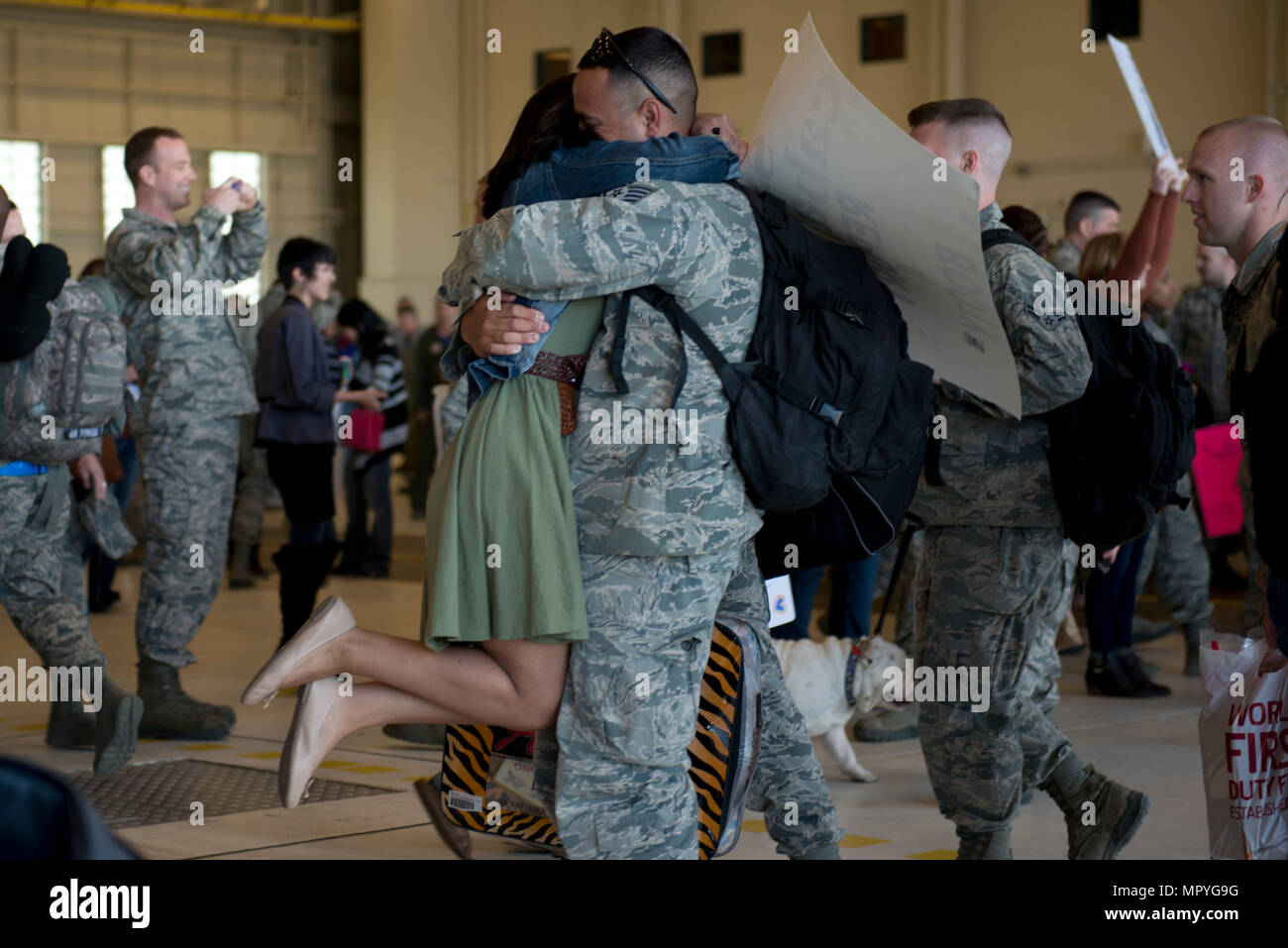 Jessica Caballero hugs her husband Air Force Staff Sgt. Timothy Caballero, a 3rd Maintenance Squadron low-observable technican returning with the 525th Fighter Squadron at Hangar 25 on Joint Base Elmendorf-Richardson, Alaska April 21. For many families, this was their first time being separated from their loved ones for an extended period of time. (U.S. Air Force photo by Senior Airman Kyle Johnson) Stock Photo