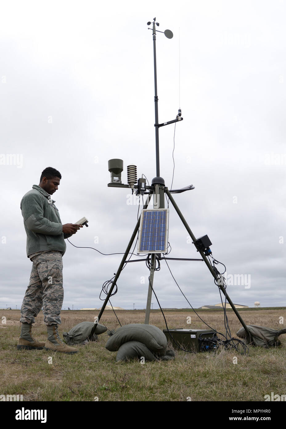 Airman 1st Class Errol Petgrave, 5th Operations Support Squadron weather forecaster, inspects the Deployed Tactical Meteorological Observing System for damage at Minot Air Force Base, N.D., April 18, 2017. Petgrave is checking the statistics and the raw data from the TMQ-53, which afterwards sends the data to their computer. (U.S. Air Force photos/Airman 1st Class Dillon Audit) Stock Photo