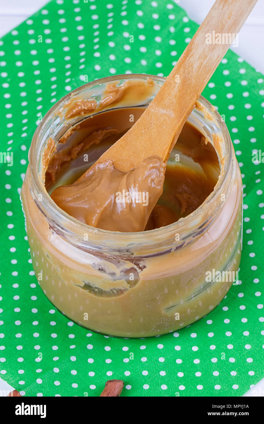 an open jar of peanut butter with spoon Stock Photo Alamy