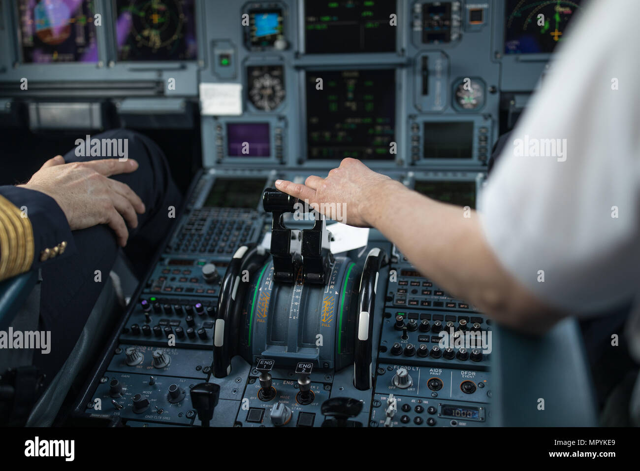 Pilot's hand accelerating on the throttle in a commercial airliner ...