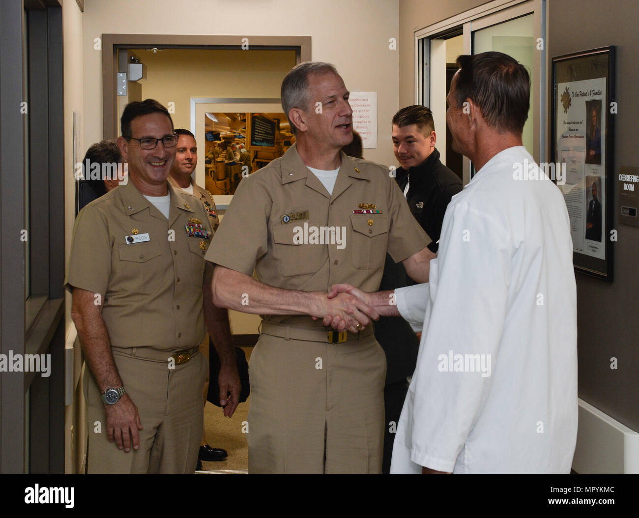 170424-N-MD713-013 SAN DIEGO (April 24, 2017) Dr. Kerry King (right), medical director, Naval Medical Center San Diego (NMCSD) Surgical Simulation Center, greets Rear Arm. Paul Pearigen, commander, Navy Medicine West, before touring the training spaces. Pearigen toured NMCSD and visited the Medical and Surgical Sim Center, Bio Skills Training Center and Emergency Department before holding an Admiral’s call and answering Sailors’ questions. (U.S. Navy photo by Mass Communication Specialist Seaman Cameron Pinske/Released) Stock Photo