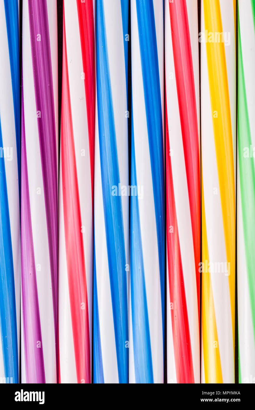 Background stripes multicolored smoothies plastic cocktail straws Stock Photo