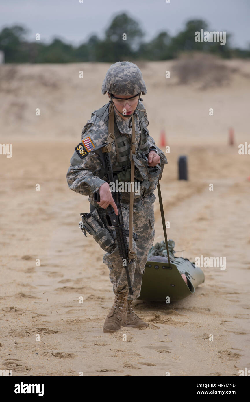 Vermont Army National Guard Specialist Avery Cunningham carries a rescue dummy on a litter from one end of the firing range to another during a training scenario at the Region One Best Warrior Competition at Joint Base McGuire-Dix-Lakenhurst on 26 April 2017.    Fourteen Soldiers are competing in the three-day event, April 25-27, 2017, which features timed events, including urban warfare simulations, a 12-mile ruck march, land navigation, and the Army Physical Fitness Test. The two winners will go on to compete in the 2017 Army National Guard Best Warrior Competition to be named the Army Guard Stock Photo