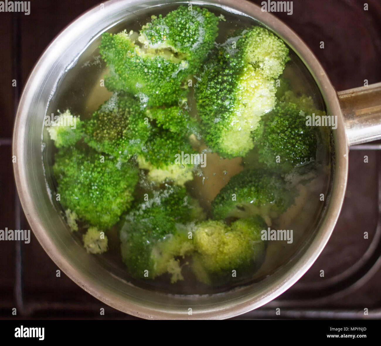 broccoli pieces cooked in the boiling water Stock Photo Alamy