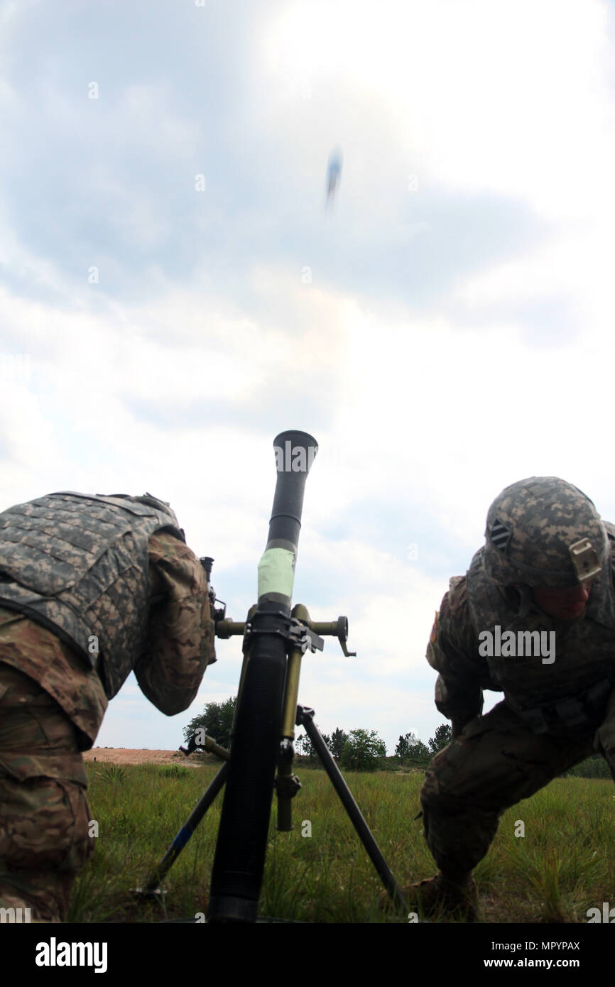 Spc. Adivas Booker (left), gunner, and Pfc. Nicholas Fitch, assistant gunner, both mortarman with 3rd Battalion, 15th Infantry Regiment, 2nd Infantry Brigade Combat Team, 3rd Infantry Division, kneel after firing an 81 mm mortar during the 3rd Infantry Division Headquarters Battalion’s base defense live-fire exercise April 27, 2017 at Fort Stewart, Ga. The mortar platoon provided fire support to division staff who were preparing for an upcoming deployment to Afghanistan which is slated for this summer. (U.S. Army photo by Staff Sgt. Candace Mundt/Released) Stock Photo