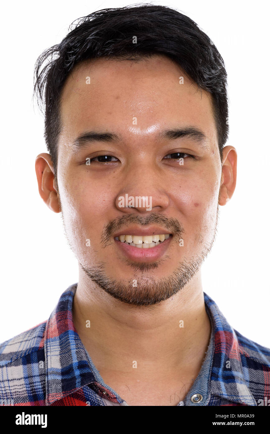 Face of young happy Asian man smiling Stock Photo