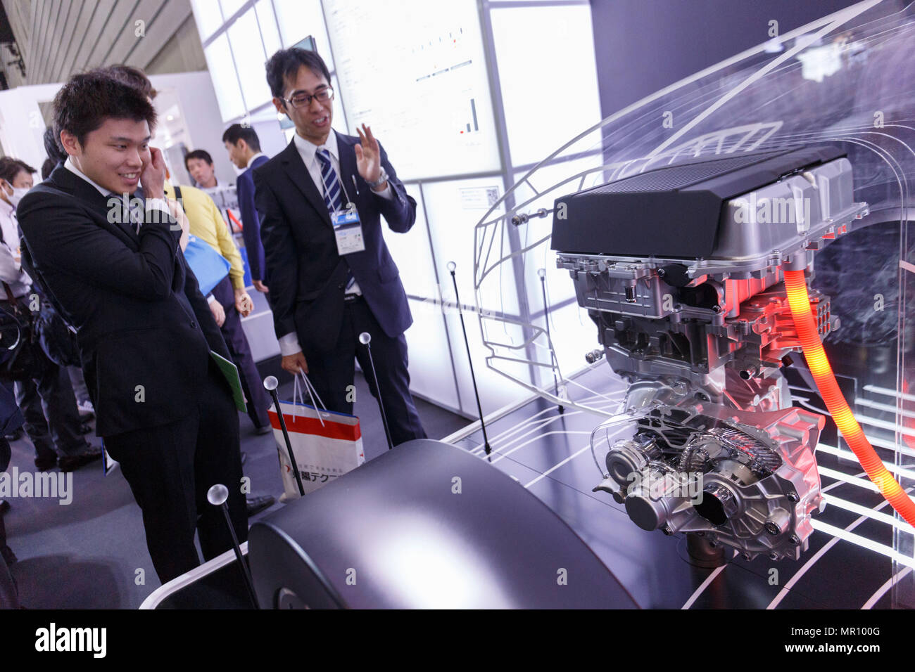 Visitors look at the latest technology products from the automotive