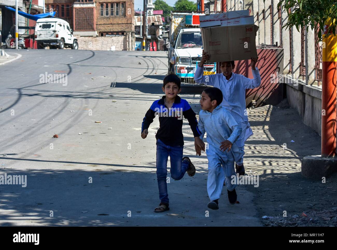 Kashmiri children run for cover as protesters clash with Indian government forces in Srinagar, Indian administered Kashmir.  Fierce clashes broke out between government forces and Kashmiri protesters in Srinagar on Friday. Scores of people were injured after government forces fired shotgun pellets and smoke shells on Kashmiri protesters who gathered after the mandatory Friday congregational prayers. Credit: SOPA Images Limited/Alamy Live News Stock Photo