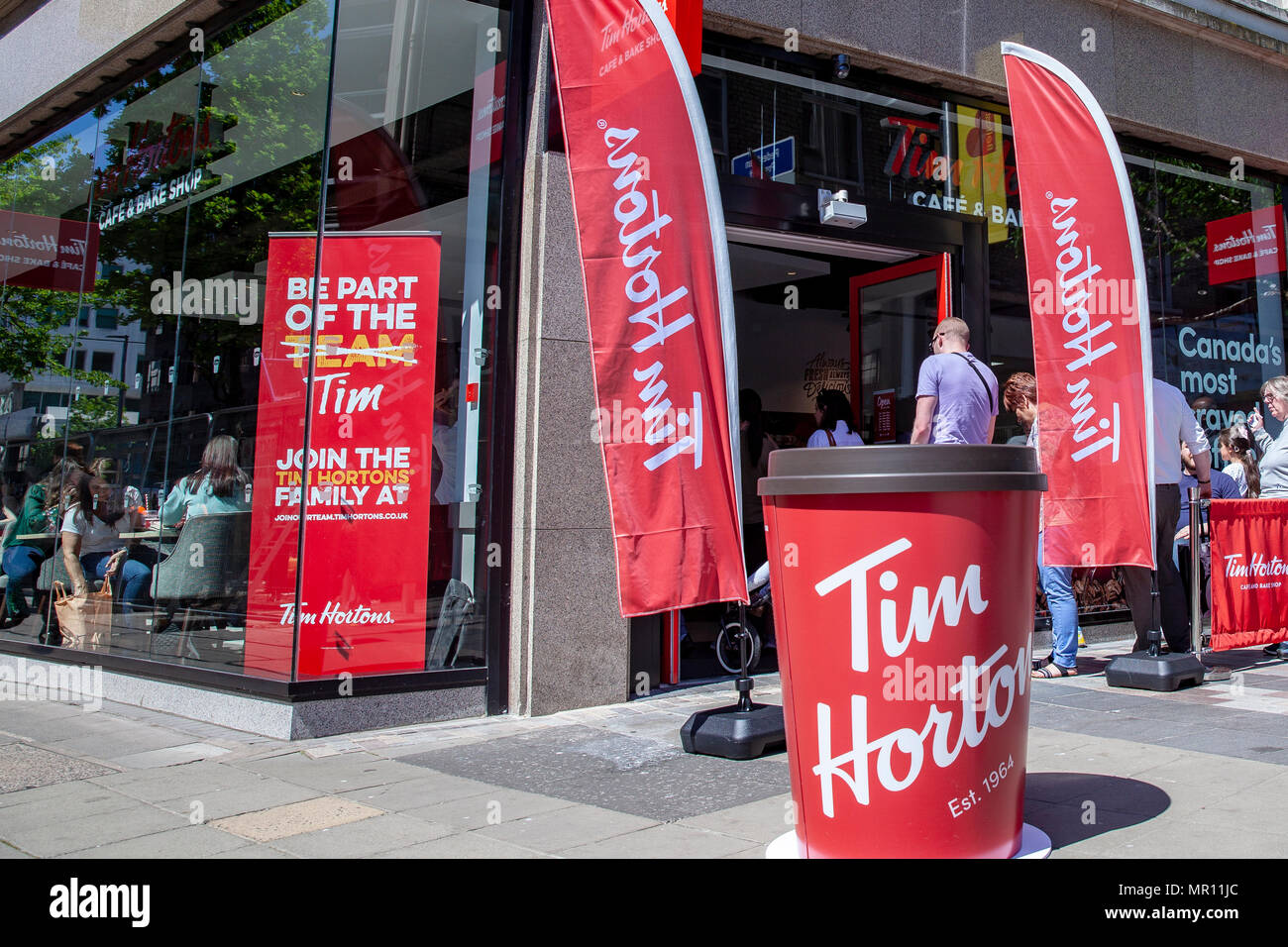 Fountain Street,Belfast, Northern Ireland.25th May 2018. Long queues formed when members of the public got in line to try the Coffee and Doughnuts at the newly opened Canadian Doughnut and Coffee chain Tim Hortons. It it its first restaurant in Northern Ireland Photo: Sean Harkin/Alamy Live News  Stock Photo