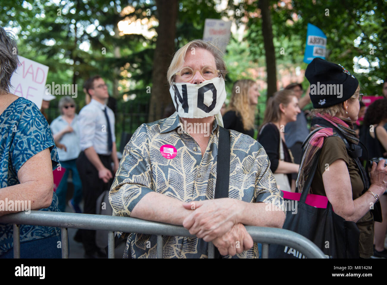 New York, USA. 24th May 2018. A woman wearing a 'NO' speech mask covering her mouth at a Title X (Title Ten) gag rule rally in New York City, hosted by Planned Parenthood of New York City on May 24th 2018, reacting the President Trump's attempt to ban Medicaid and federal funding to medical providers who provide full, legal medical information to patients wanting or needing abortion services. Credit: Brigette Supernova/Alamy Live News Stock Photo