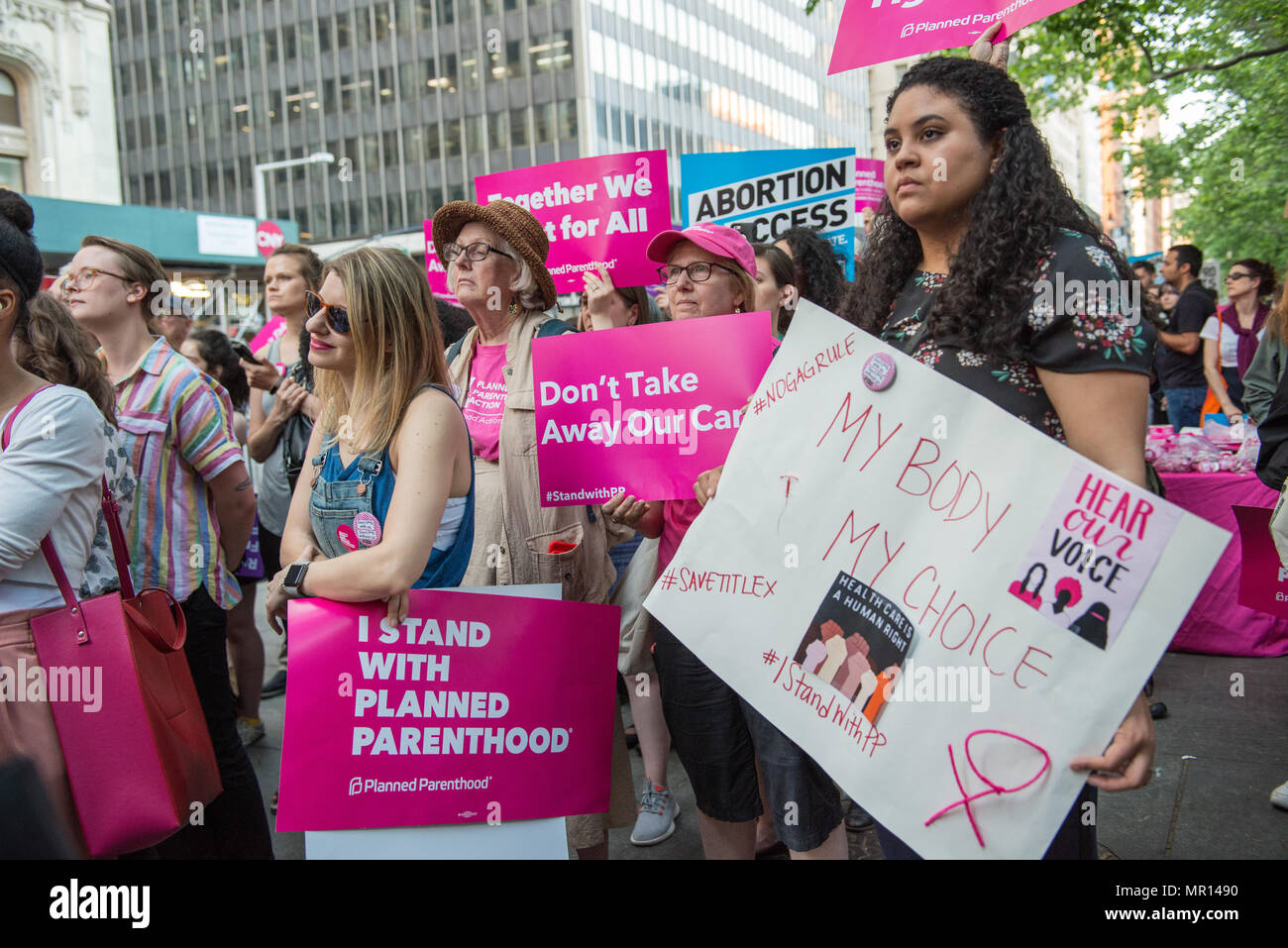 Supporters with signs at a Title X (Title Ten) gag rule rally in New York City, hosted by Planned Parenthood of New York City on May 24th 2018, reacting the President Trump's attempt to ban Medicaid and federal funding to medical providers who provide full, legal medical information to patients wanting or needing abortion services. Stock Photo