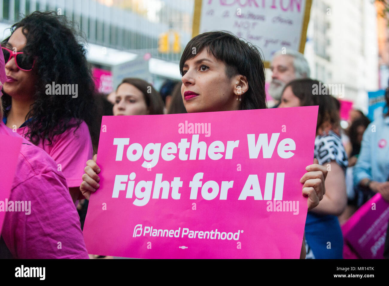 Supporters with signs at a Title X (Title Ten) gag rule rally in New York City, hosted by Planned Parenthood of New York City on May 24th 2018, reacting the President Trump's attempt to ban Medicaid and federal funding to medical providers who provide full, legal medical information to patients wanting or needing abortion services. Stock Photo