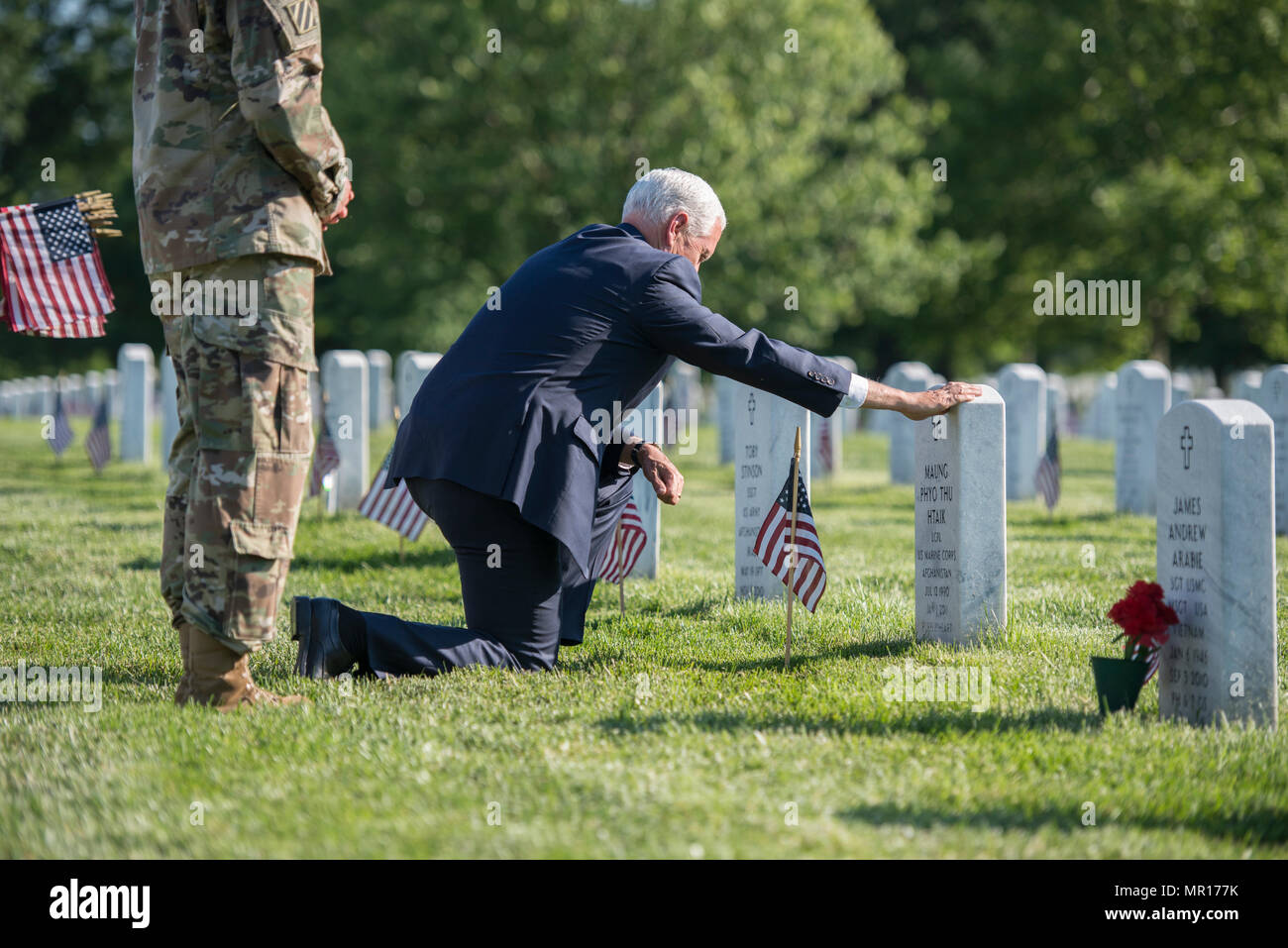 Virginia, USA, 25 May 2018. U.S. Vice President Mike Pence places a flag at a gravesite of soldier killed in Afghanistan in Section 60 of Arlington National Cemetery to mark Memorial Day May 24, 2018 in Arlington, Virginia. Credit: Planetpix/Alamy Live News Stock Photo