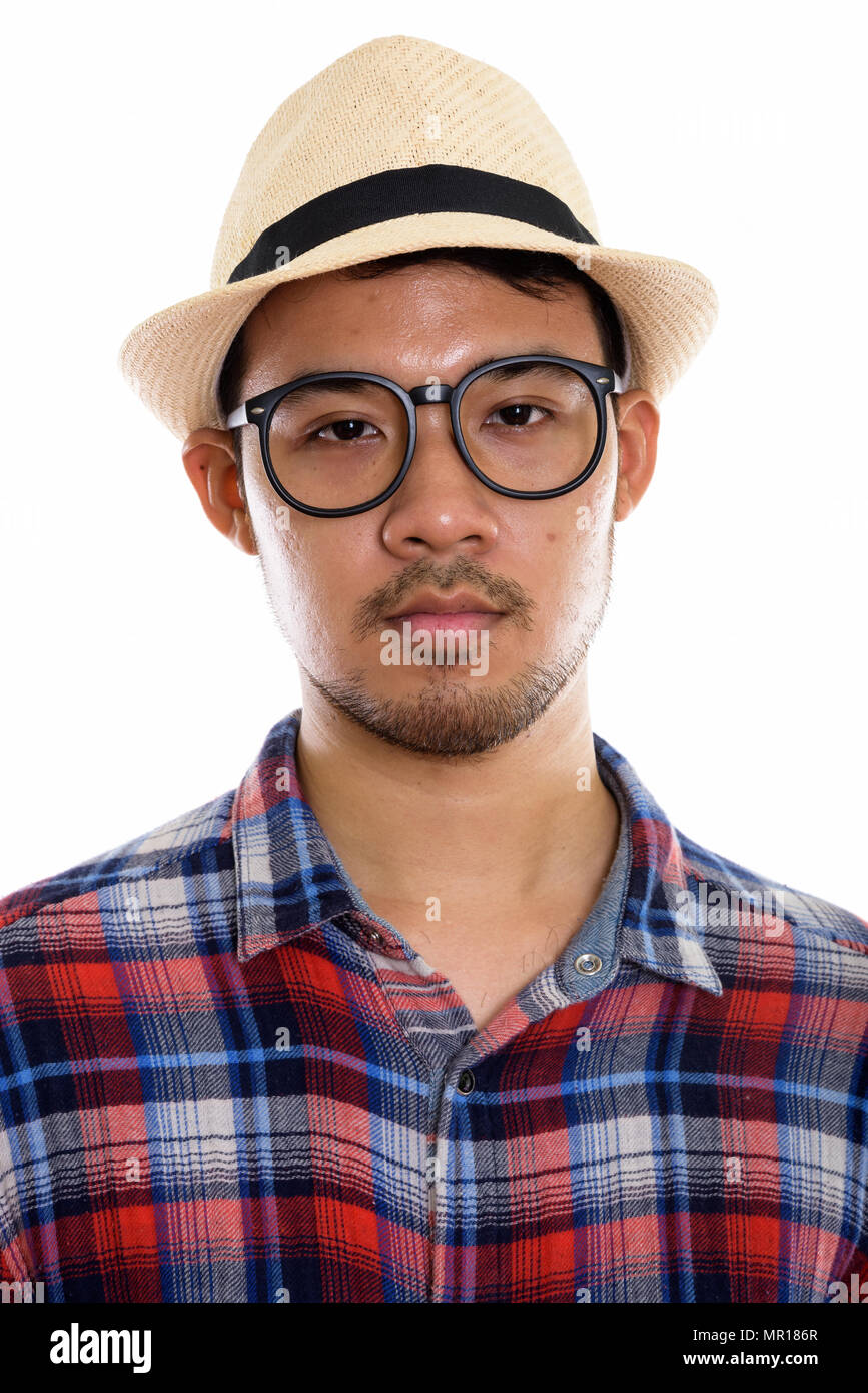Face of young Asian man wearing eyeglasses and hat Stock Photo