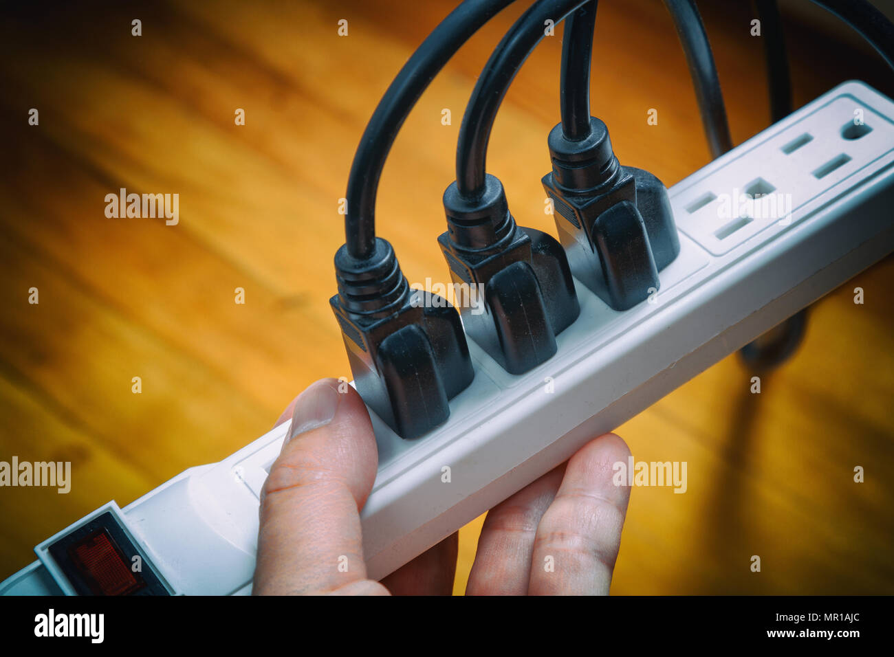 electrical plugs connected to a power strip Stock Photo