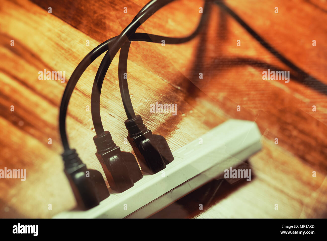 electrical plugs connected to a power strip Stock Photo