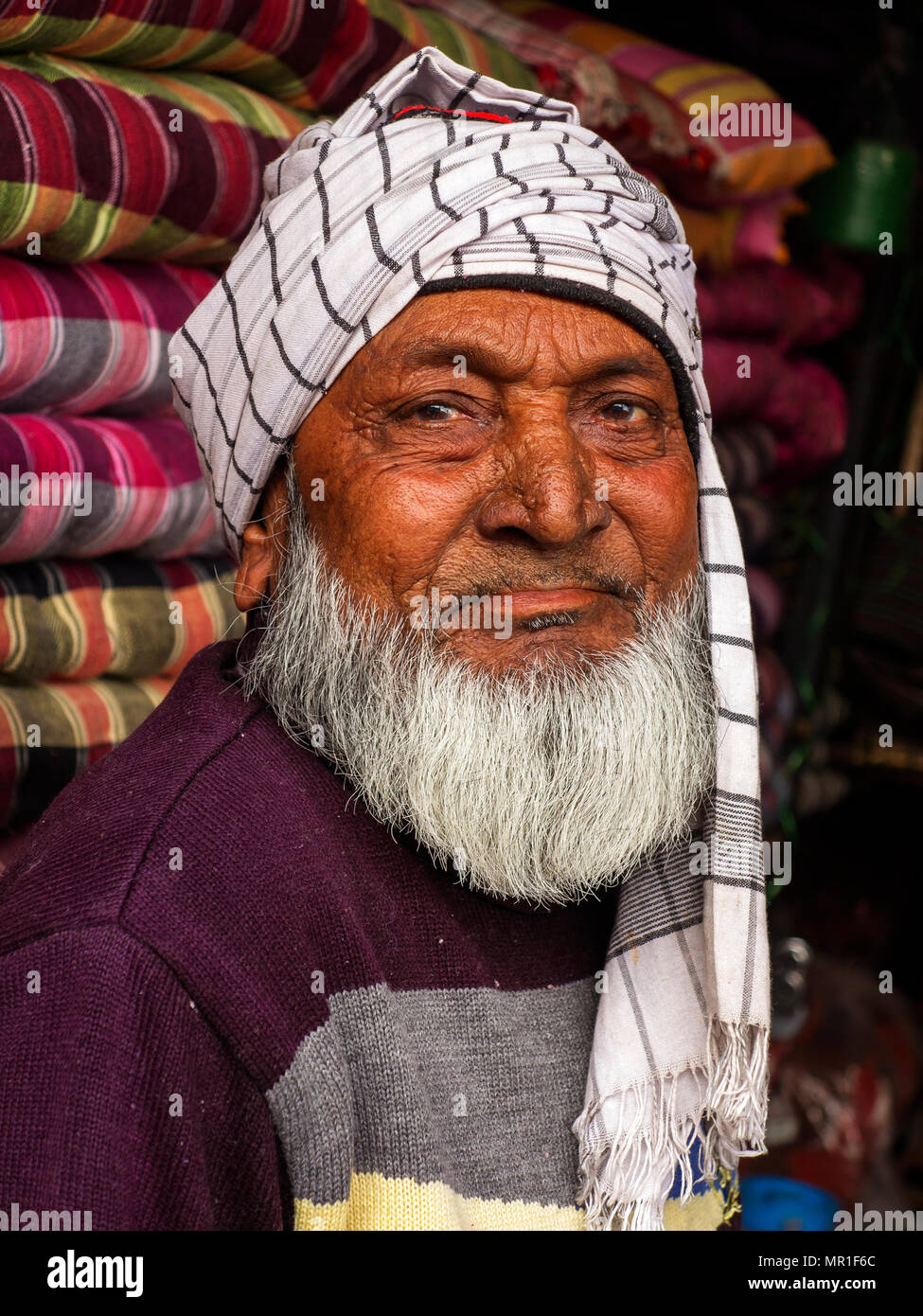Old indian man at his blanket shop at Champawatt town, Kumaon Hills, Uttarakhand, India Stock Photo