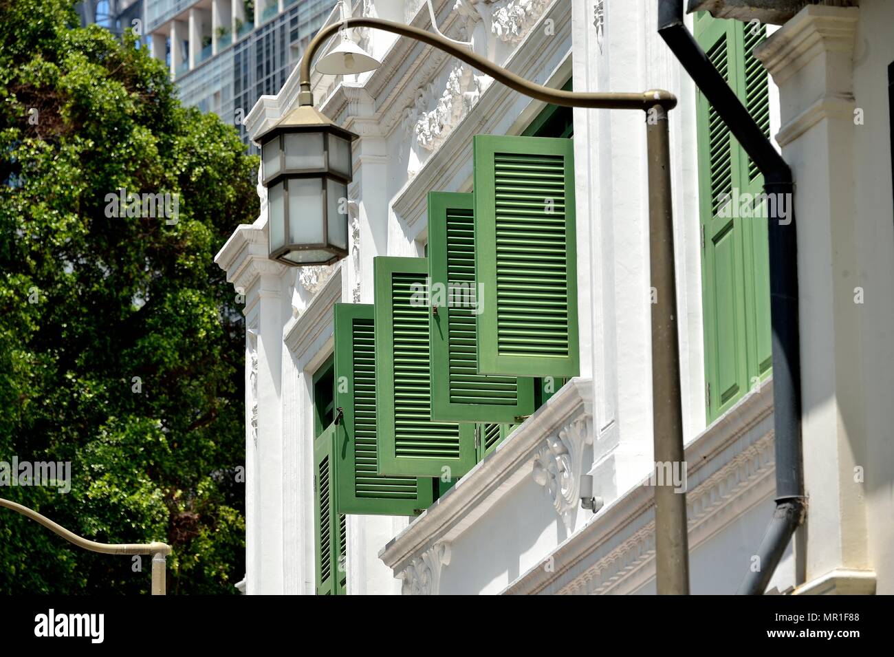 Perspective view of vintage traditional Singapore Peranakan or Straits Chinese shop house with antique green wooden shutters in historic Chinatown Stock Photo