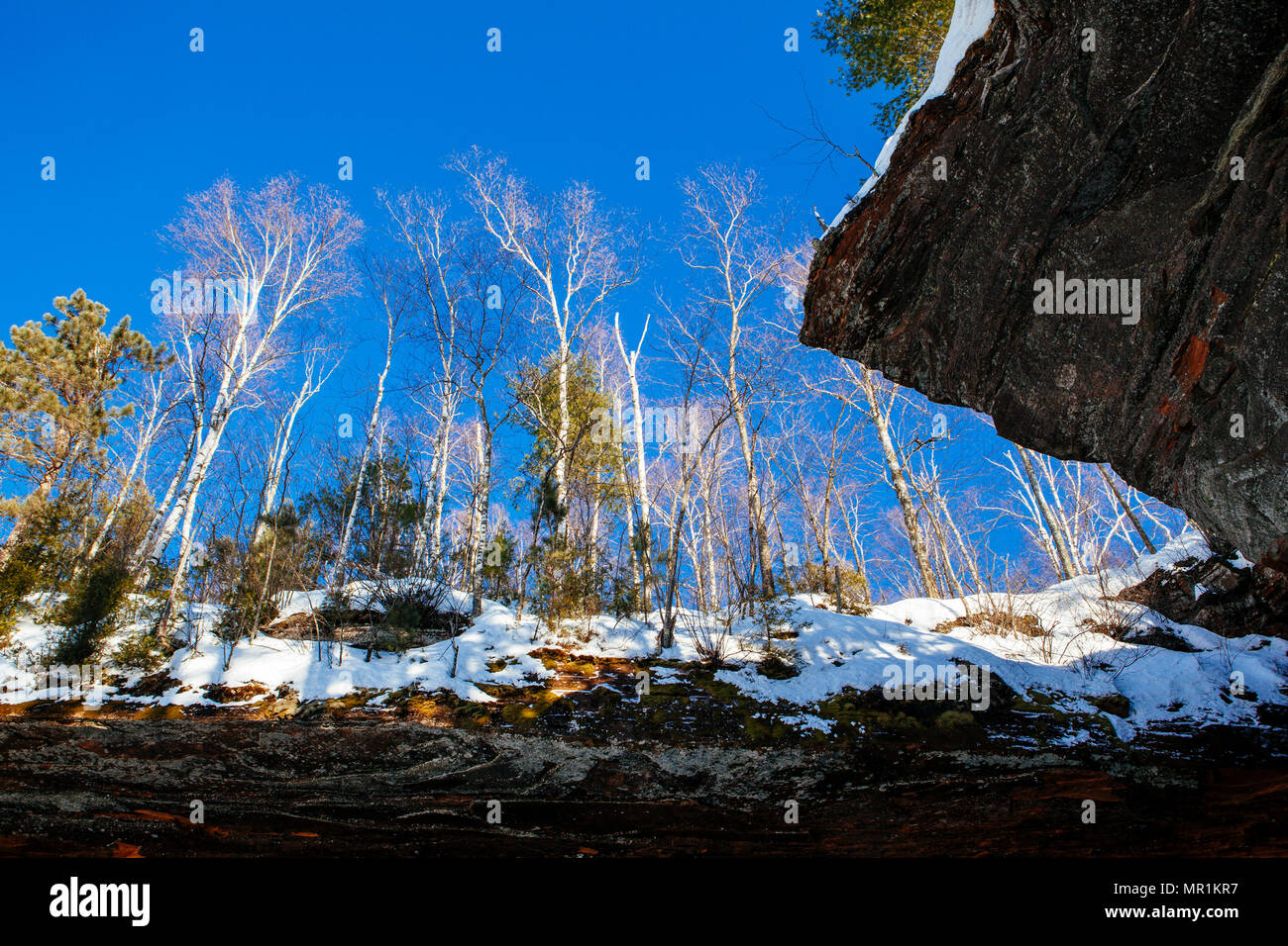 Red rock caves are ice covered along the shoreline of the Apostle