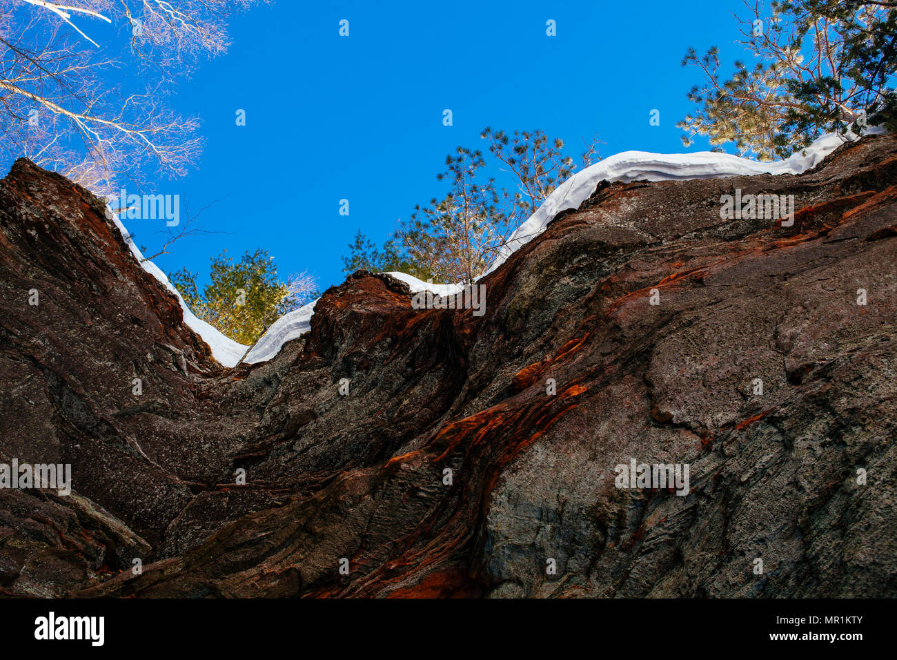 Red rock caves are ice covered along the shoreline of the Apostle