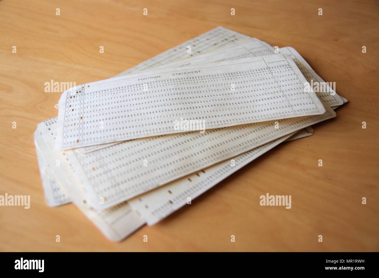 Pile of punched cards containing FORTRAN code Stock Photo