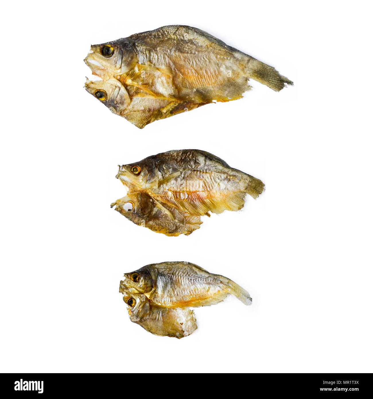 Dry fish from the sun on the white background, pattern of dried fish and small dried fish, top view of dry fish on the white background for isolated Stock Photo