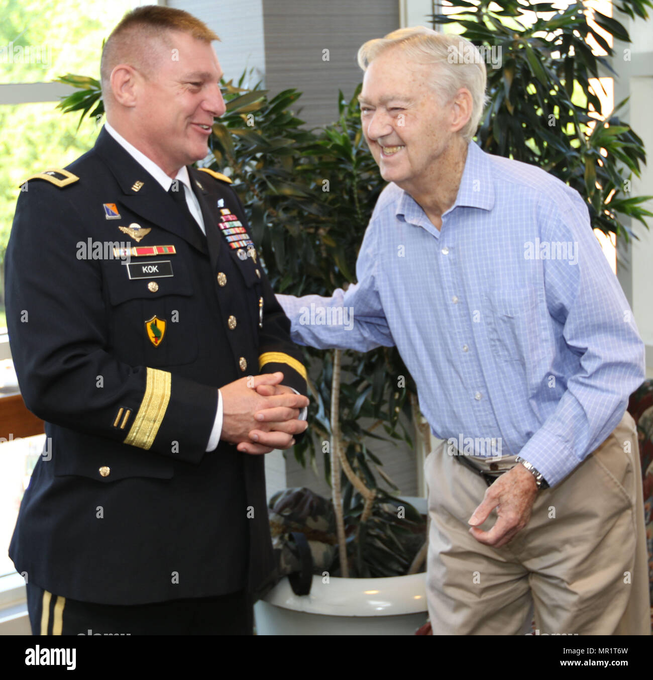 Maj. Gen. Troy D. Kok, commanding general of the U.S. Army Reserve’s 99th Regional Support Command, shares a moment with Claude Hodges, a 99th Infantry Division veteran who served during the Battle of the Bulge and is currently a resident at the Virginia Veterans Care Center in Roanoke, Virginia. Kok visited Hodges and other veterans at the center April 28. Stock Photo