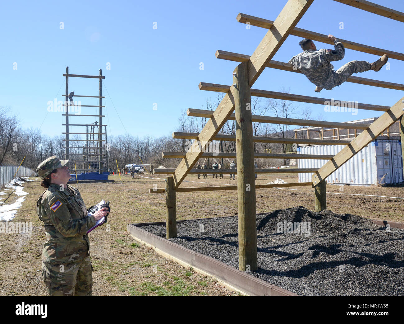 Sgt. Andrew Urbaez struggles to pull himself over and under each bar on