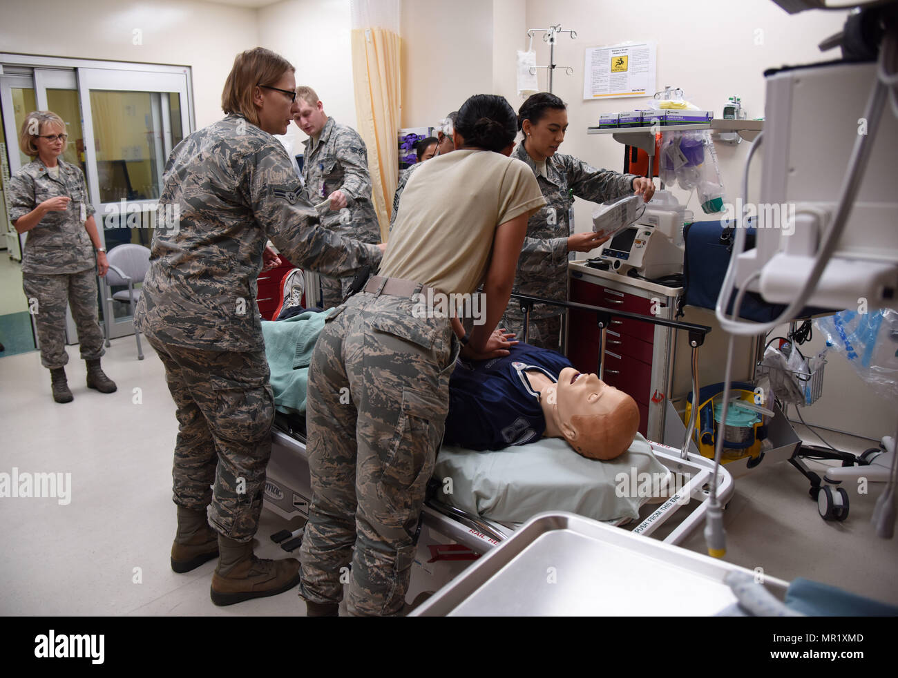 Members of the 81st Medical Operations Squadron participate in a medical emergency scenario during Code Blue Thursday in the Keesler Medical Center emergency room April 27, 2017, on Keesler Air Force Base, Miss. Emergency room staff members coordinated with the simulation lab to use human patient simulators for running various advanced cardiac life support scenarios to improve Keesler’s new medical technicians’ skills and get them familiar with emergency equipment. (U.S. Air Force photo by Kemberly Groue) Stock Photo