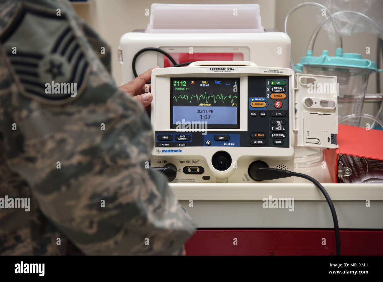 Master Sgt. Juan Diaz, 81st Medical Operations Squadron medical technician, operates a defibrillator during Code Blue Thursday in the Keesler Medical Center emergency room April 27, 2017, on Keesler Air Force Base, Miss. Emergency room staff members coordinated with the simulation lab to use human patient simulators for running various advanced cardiac life support scenarios to improve Keesler’s new medical technicians’ skills and get them familiar with emergency equipment. (U.S. Air Force photo by Kemberly Groue) Stock Photo
