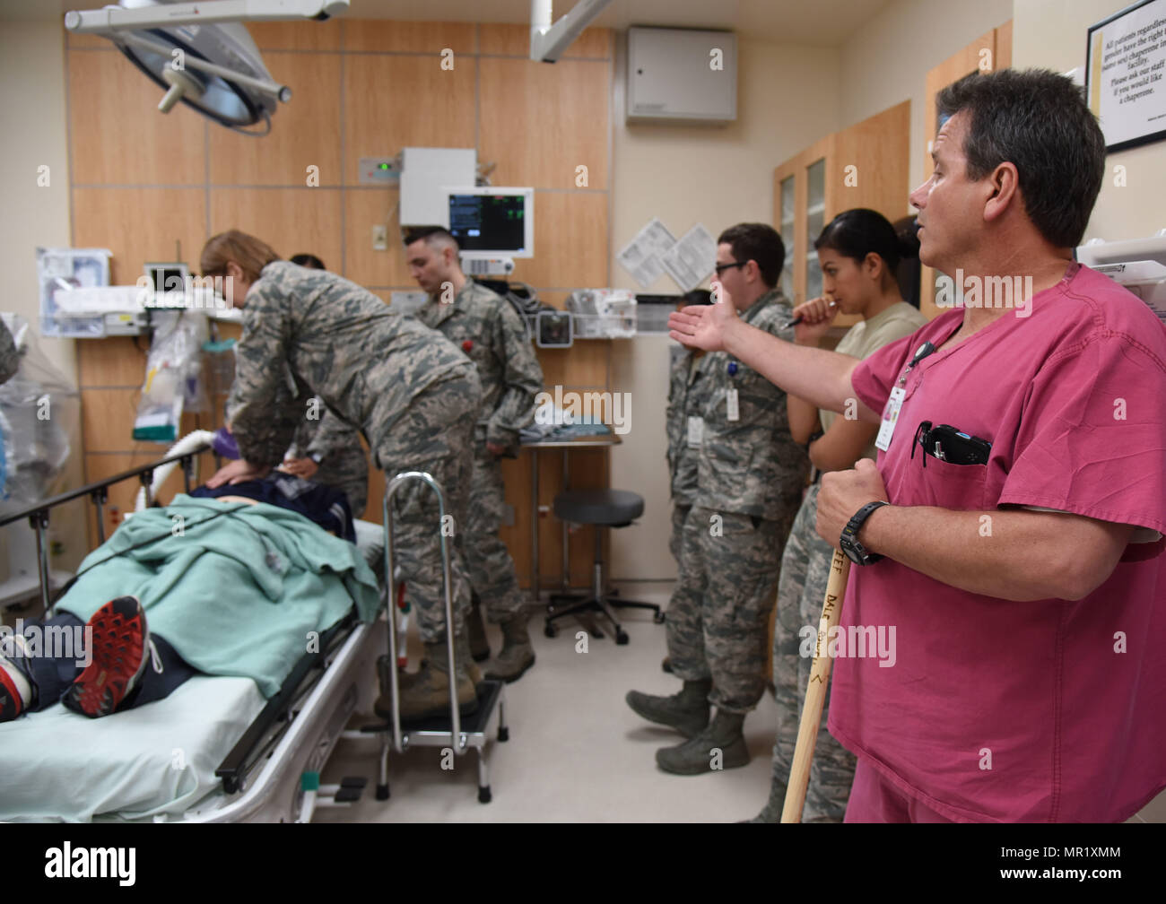 Dale Rowell, 81st Medical Operations Squadron charge nurse, instructs staff members as they participate in a medical emergency scenario during Code Blue Thursday in the Keesler Medical Center emergency room April 27, 2017, on Keesler Air Force Base, Miss. Emergency room staff members coordinated with the simulation lab to use human patient simulators for running various advanced cardiac life support scenarios to improve Keesler’s new medical technicians’ skills and get them familiar with emergency equipment. (U.S. Air Force photo by Kemberly Groue) Stock Photo