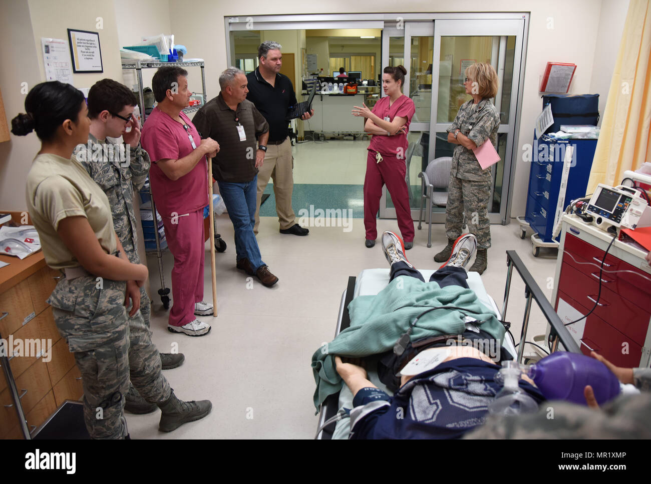 Members of the 81st Medical Operations Squadron participate in a “hot wash” following a medical emergency training scenario during Code Blue Thursday in the Keesler Medical Center emergency room April 27, 2017, on Keesler Air Force Base, Miss. Emergency Room staff members coordinated with the simulation lab to use human patient simulators for running various advanced cardiac life support scenarios to improve Keesler’s new medical technicians’ skills and get them familiar with emergency equipment. (U.S. Air Force photo by Kemberly Groue) Stock Photo