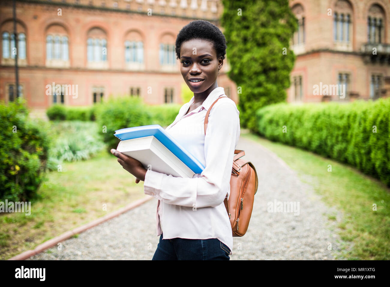 cheerful african college girl outdoors on modern campus Stock Photo - Alamy