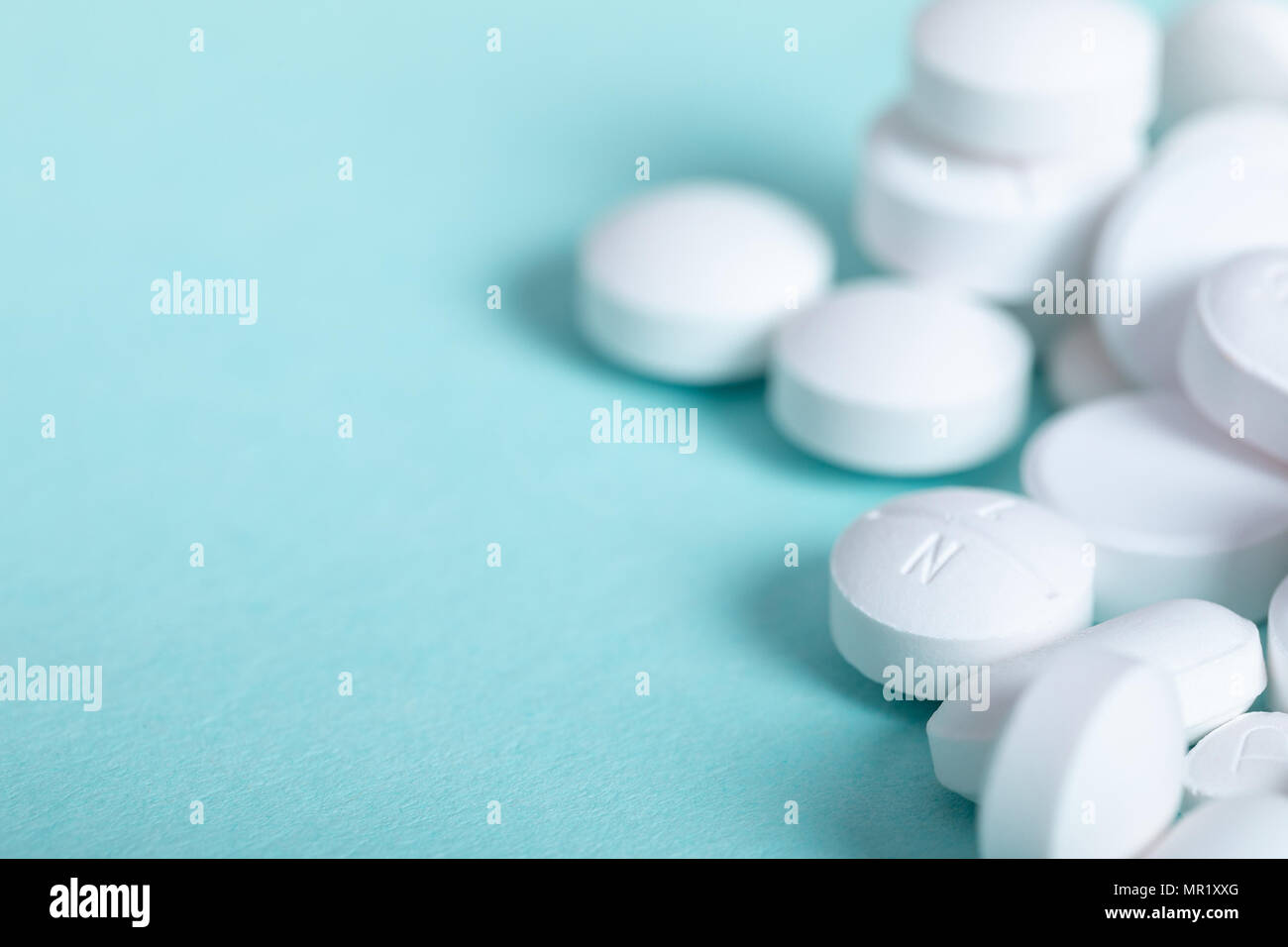 white pills on blue background Stock Photo