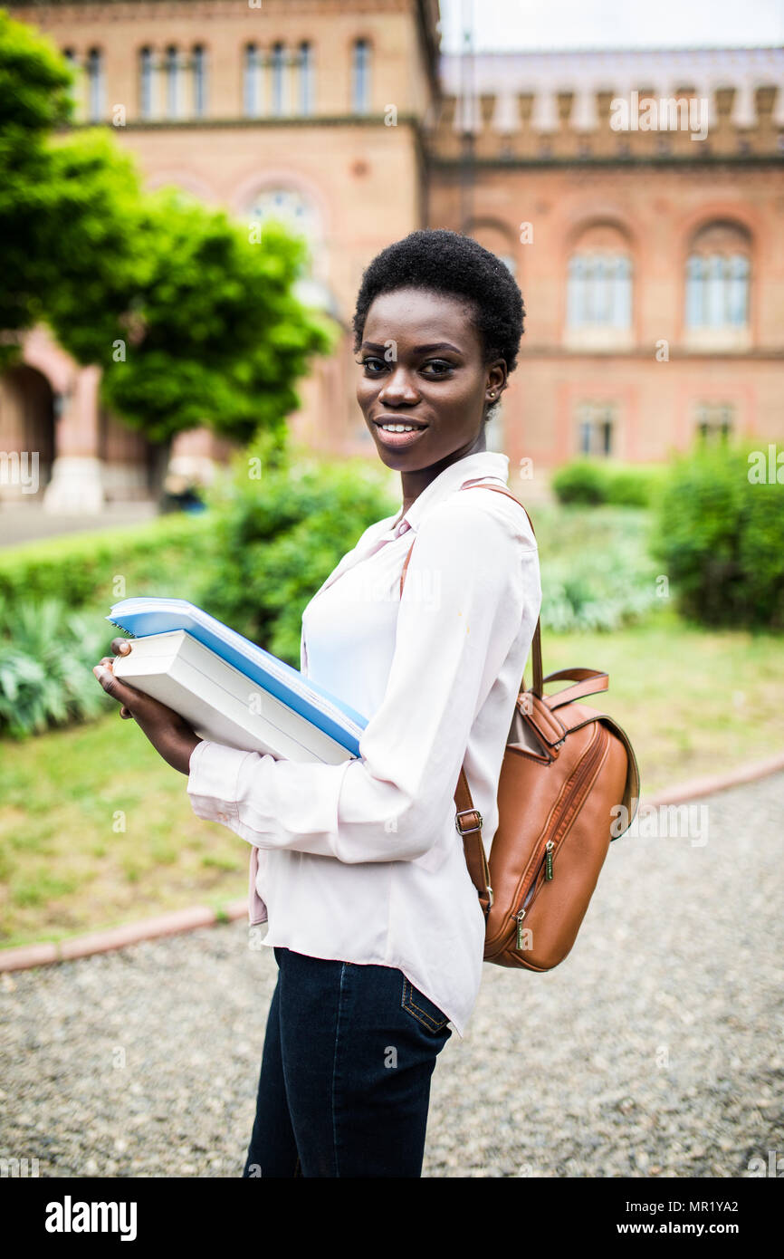 cheerful african college girl outdoors on modern campus Stock Photo - Alamy