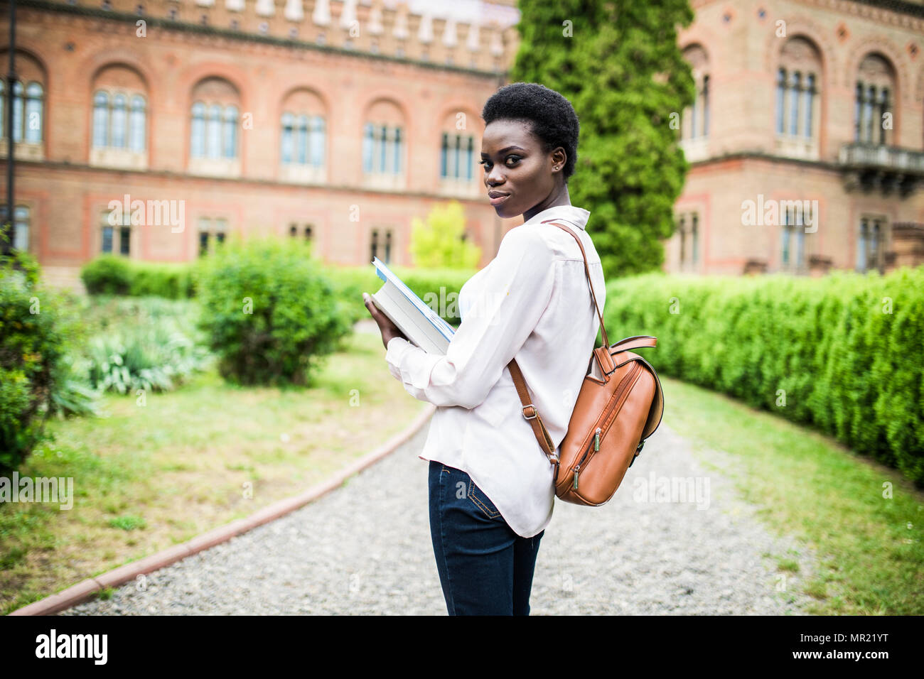 happy african college girl outdoors on modern campus Stock Photo - Alamy